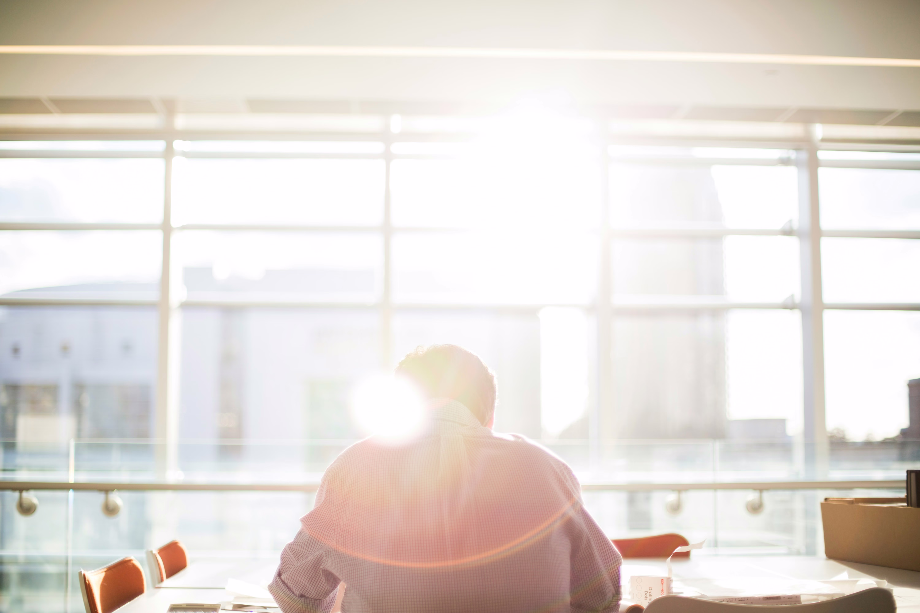 Man standing in warm sunlight by a window